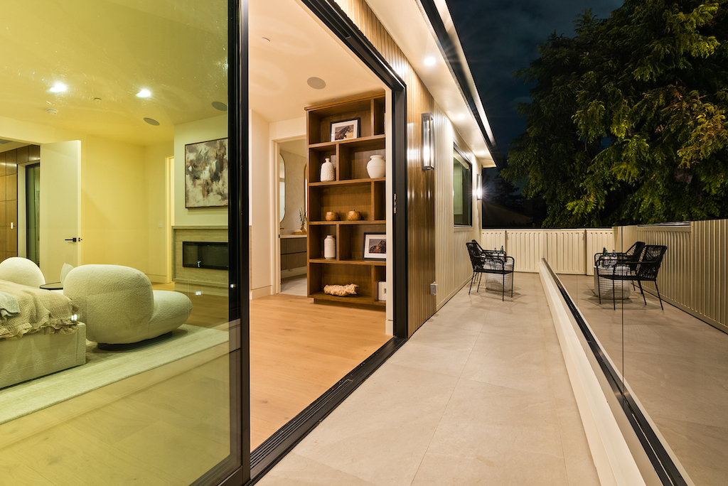 Nighttime patio with open sliding glass doors