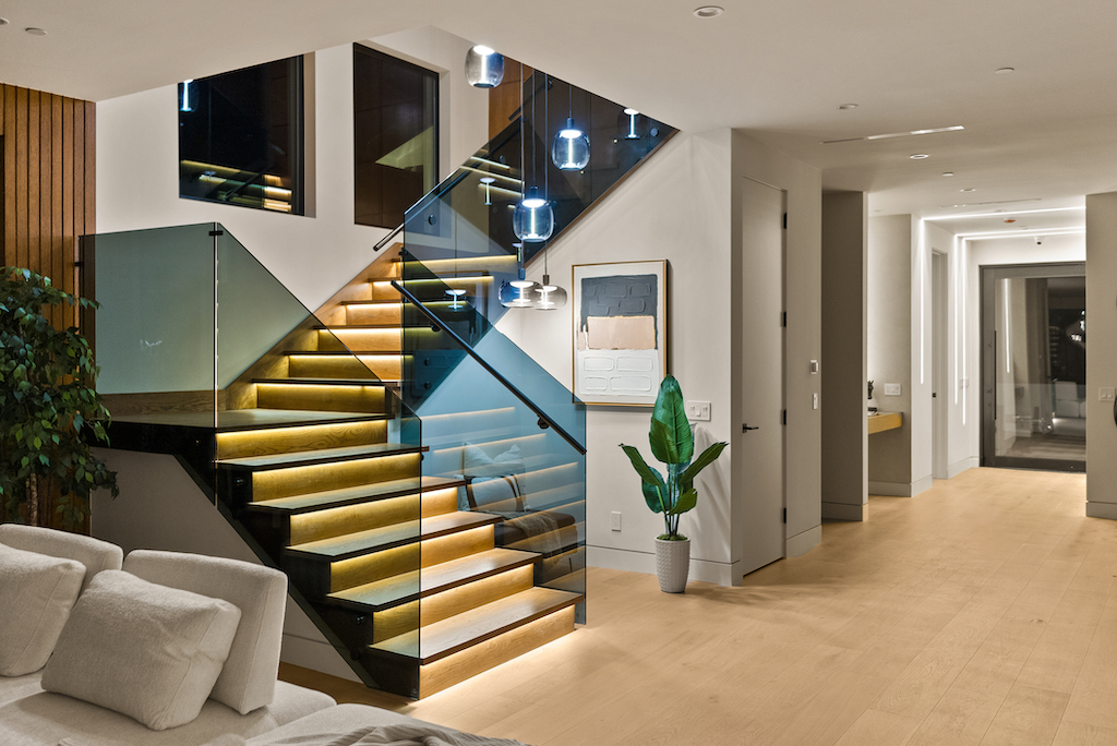 Modern home interior with illuminated glass staircase