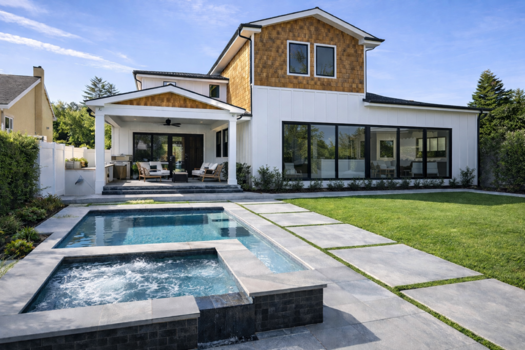 Modern house with large windows and an inviting pool area.