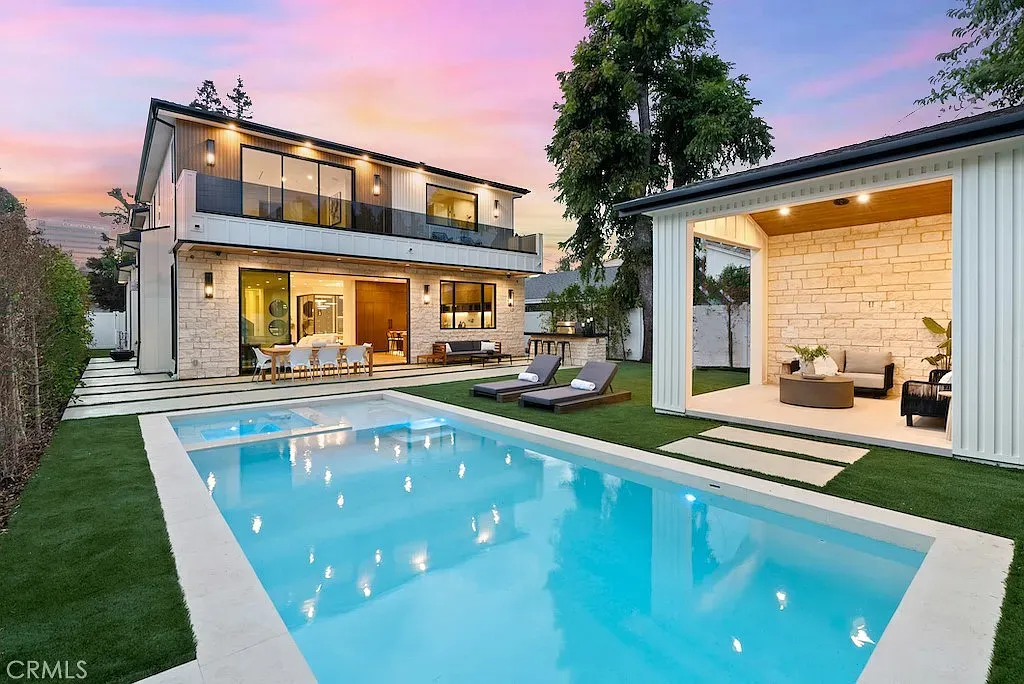 Modern house with an inviting pool at sunset.
