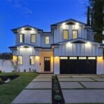 Luxury Home Builders custom home front exterior at dusk, Valley Vista project