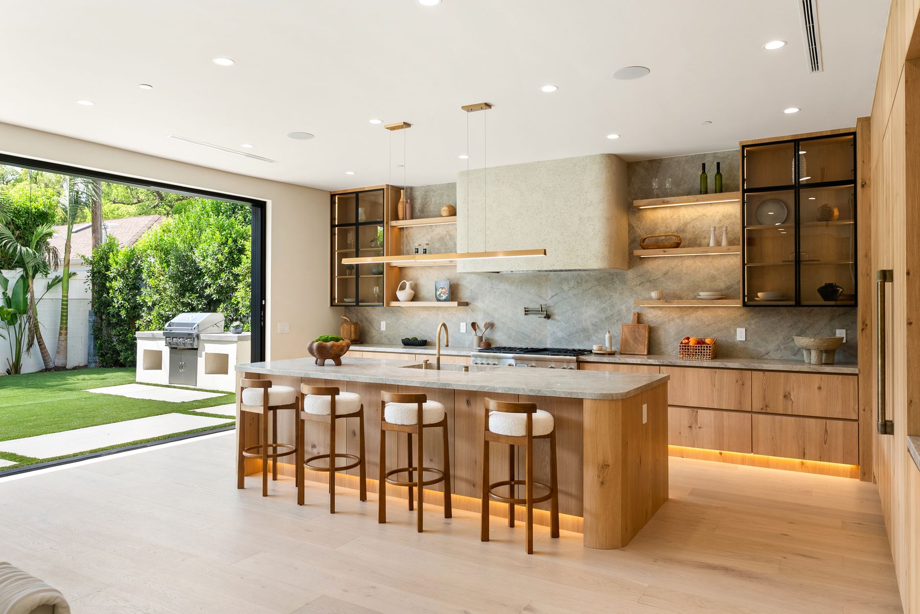 Luxury Home Builders custom home kitchen with island seating and white oak cabinetry