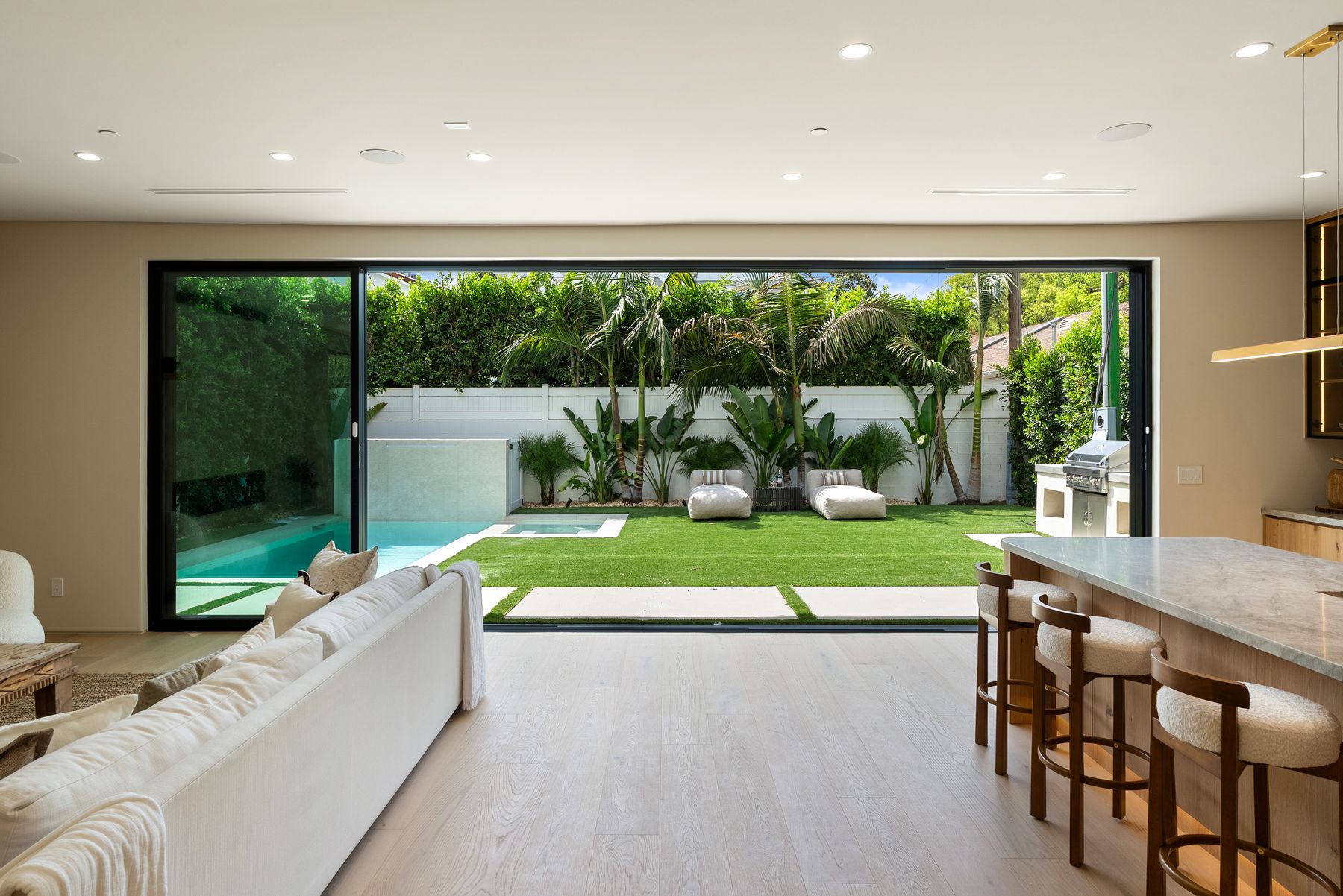 Luxury Home Builders custom home rear lawn and open great room