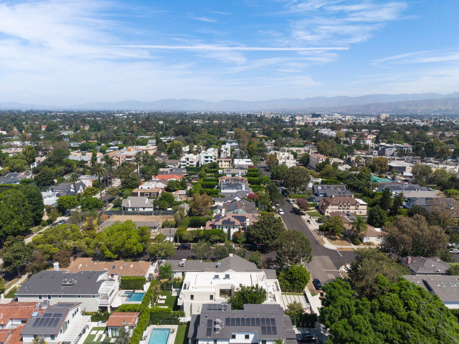 Aerial view of a Los Angeles residential neighborhood with hills in the distance