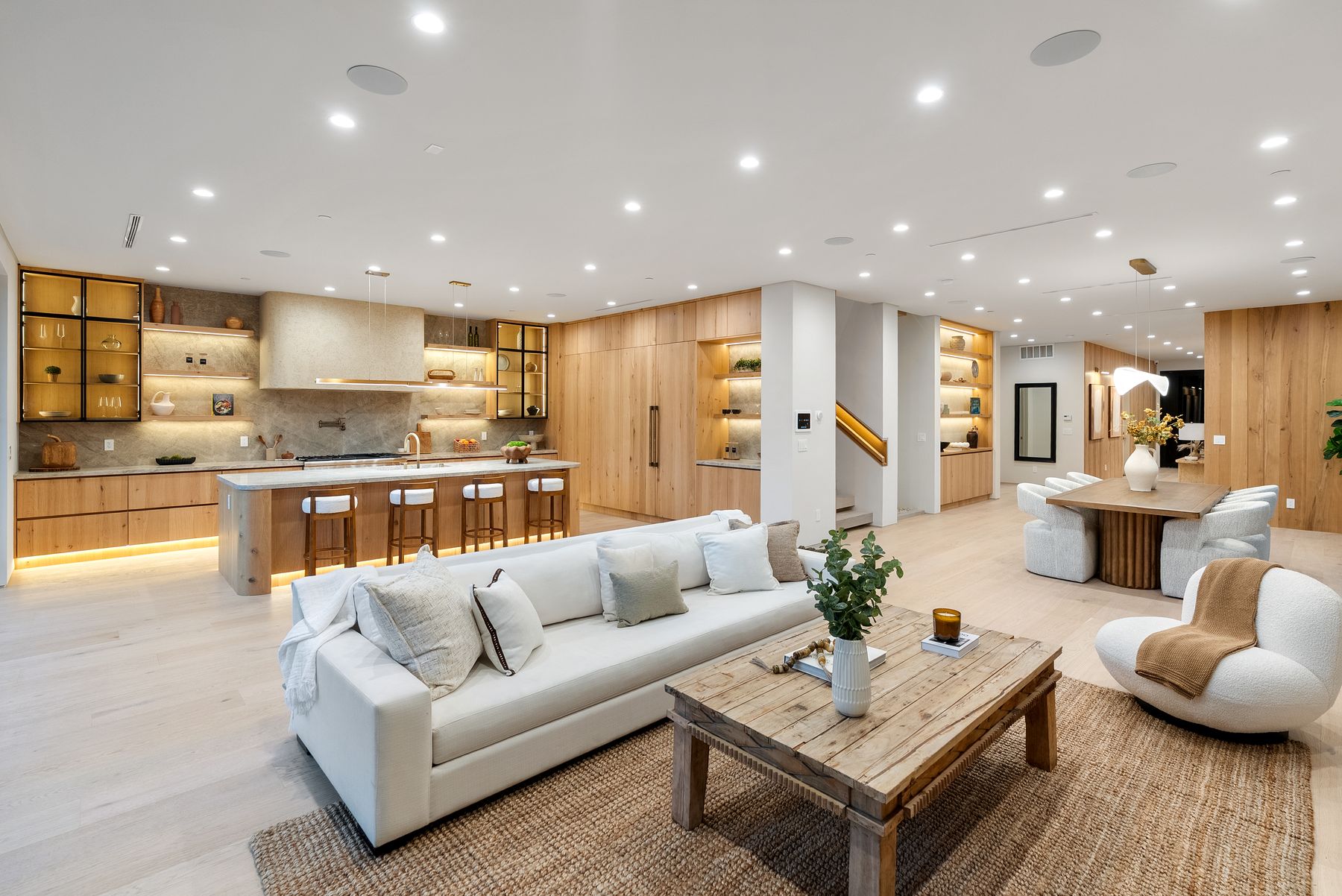 Luxury Home Builders custom home living room open to the kitchen at dusk