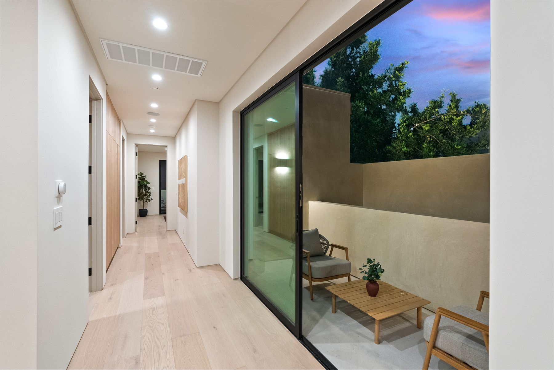 Luxury Home Builders custom home hallway with glass door to the garden
