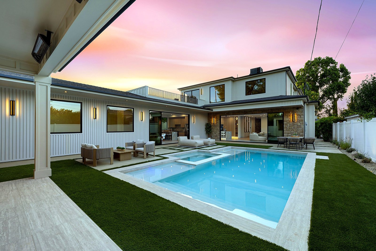 Pool and covered patio at dusk, Luxury Home Builders custom home